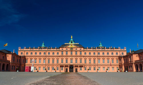 Buildings in city against blue sky