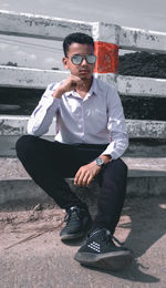 Portrait of young man sitting outdoors