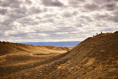 Mountain bikers ride down a steep section of trail in fruita, co.