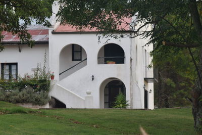 White built structure with trees in foreground