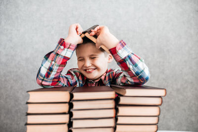 Portrait of smiling boy holding book