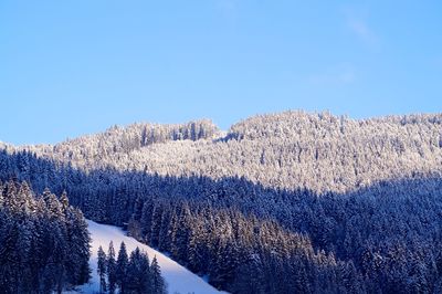 Scenic view of snowcapped mountains against clear blue sky