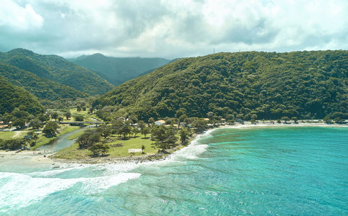 Scenic view of sea and mountains against sky