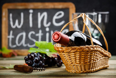 Close-up of wine bottle in basket on table