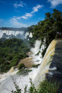 Scenic view of waterfall against sky