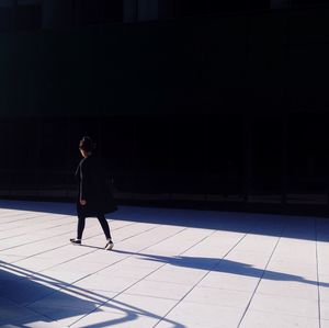 Full length of woman standing by railing