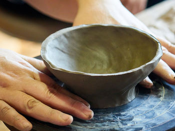 Close-up of person hand creating pottery