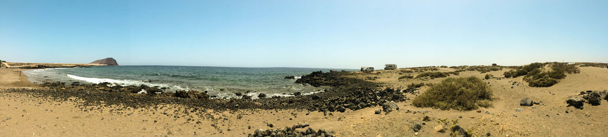 Scenic view of beach against clear sky