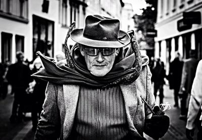 Portrait of man wearing hat standing on street