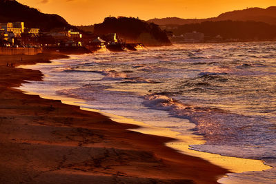 Scenic view of beach against sky during sunset