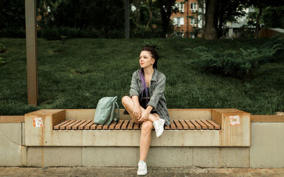 Portrait of young woman sitting on seat