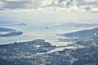 High angle view of buildings by sea against sky