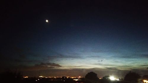 Low angle view of silhouette moon against sky at night