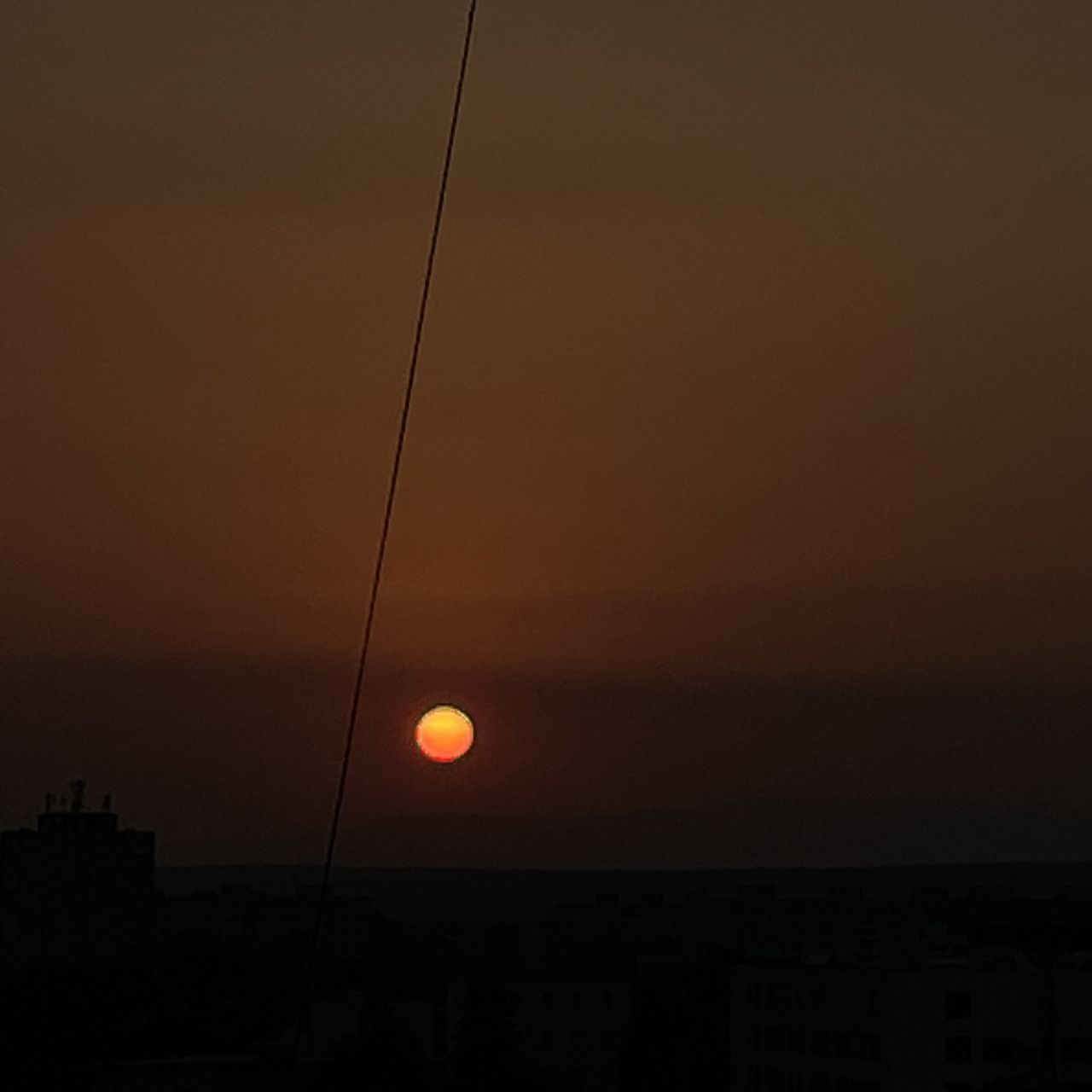 sky, sunset, sun, architecture, dawn, orange color, nature, no people, astronomical object, silhouette, light, built structure, horizon, beauty in nature, building exterior, afterglow, scenics - nature, outdoors, copy space, moon, city, evening, tranquility, tranquil scene, darkness, line, sunlight