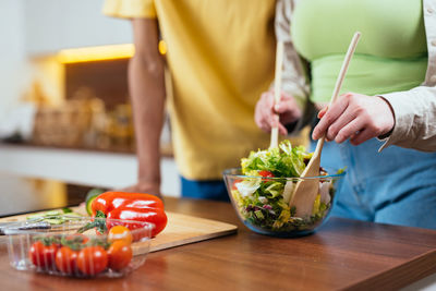 Midsection of woman preparing food on table