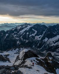 Scenic view of snowcapped mountains against sky during sunset