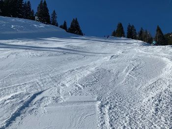 Snow covered landscape against sky