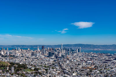 High angle view of buildings against blue sky