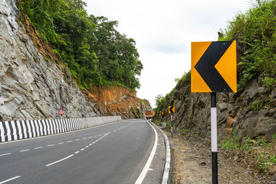 Road sign against mountain