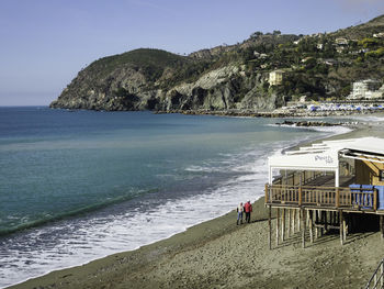 People on beach against sky