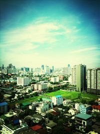 View of cityscape against cloudy sky