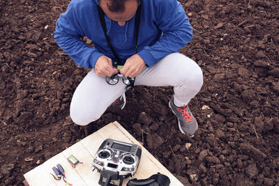 Young man prepares the drone for flight