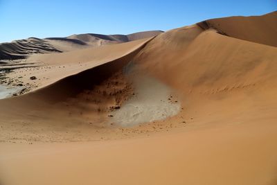 Scenic view of desert against clear sky