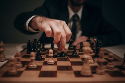 Midsection of man playing chess