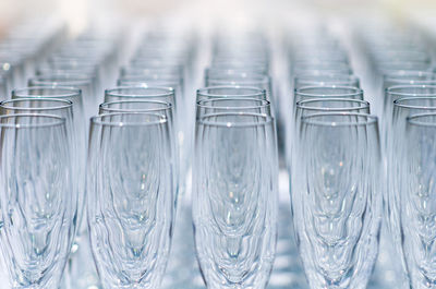 Close-up of champagne flutes arranged on table