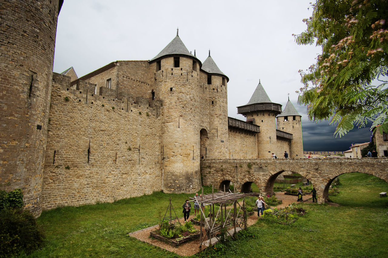 architecture, built structure, building exterior, grass, history, place of worship, religion, church, spirituality, sky, tree, the past, castle, famous place, travel destinations, day, ancient, old