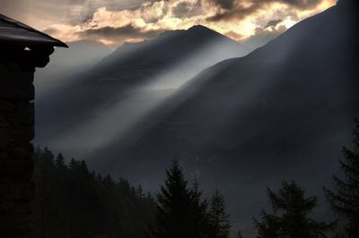 Scenic view of mountains against cloudy sky