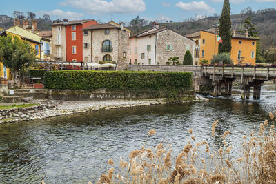 The beautiful colored houses of the hamlet of valeggio sul mincio reflecting on the water