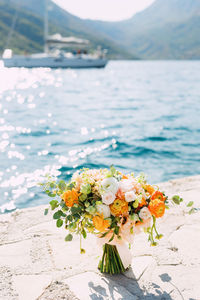 Close-up of flowering plant by sea