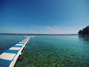 Scenic view of sea against blue sky