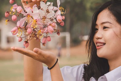 Portrait of smiling woman with plants