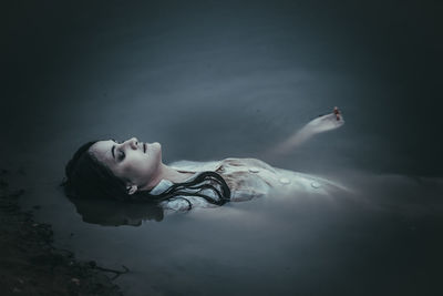 Portrait of woman lying in water