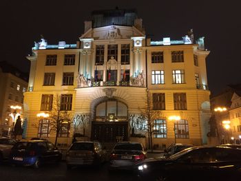 Cars on illuminated city at night