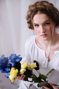 Portrait of young woman with roses