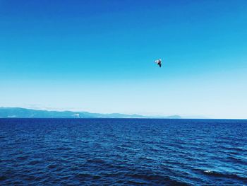 Scenic view of sea against clear blue sky