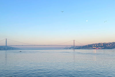 Low angle view of suspension bridge over river