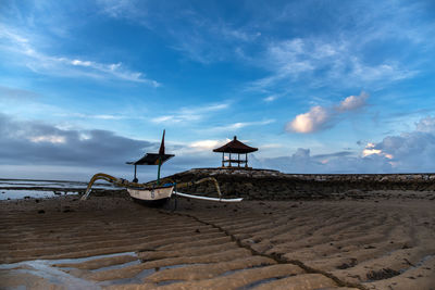 Lifeguard hut on beach against sky