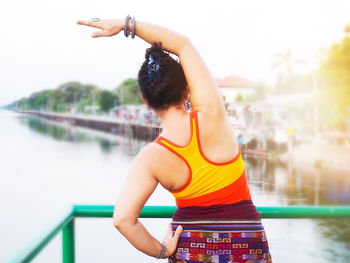 Midsection of woman standing in water