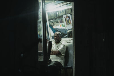 Man sitting in bus window at home