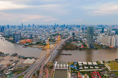 High angle view of river amidst buildings in city against sky