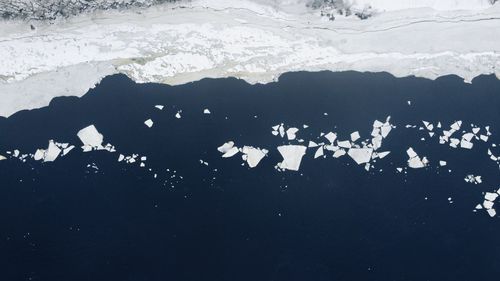 High angle view of frozen lake against mountain