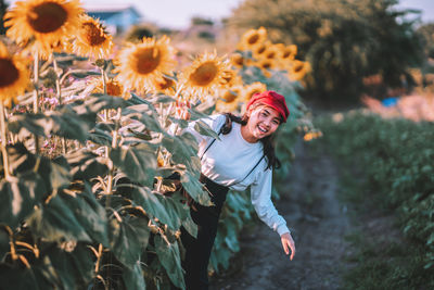 Young woman holding flower petals on land