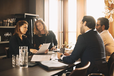 Lawyers discussing over evidence in meeting at office