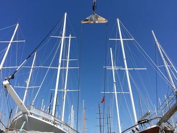 Low angle view of boats against blue sky