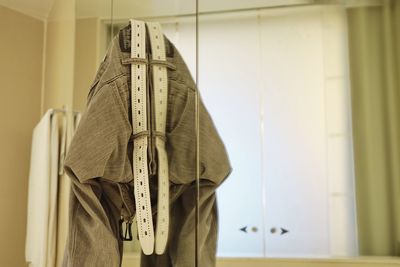 Close-up of clothes hanging on wall at home