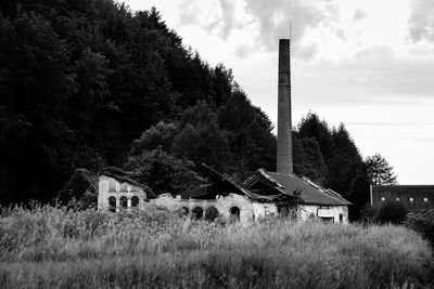 Abandoned house on field against sky